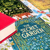 Jigsaw puzzle pieces with book-themed designs, including 'The Jungle Book' and 'The Secret Garden'.